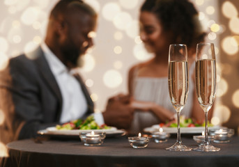 Wall Mural - Glasses of champagne and candles on dinner table