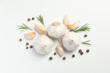 Wall Mural - Flat lay of composition, garlic bulbs, slices, spice, parsley, rosemary on white background, top view. Space for text