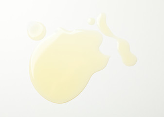 Olive oil spots on white background, top view and close up