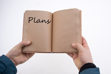 Plans written in a book in the hands of a person. Thoughts, ideas, planning