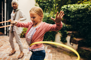 Woman and child playing with hoopla rings