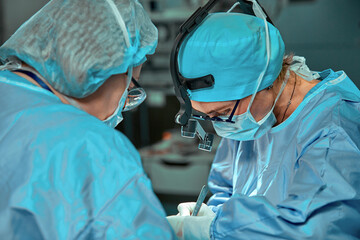 Wall Mural - Surgeons team in the operating room, portraits close-up. modern operating, plastic surgery. Beauty industry