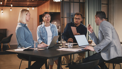 Wall Mural - Diverse group of businesspeople talking together in an office