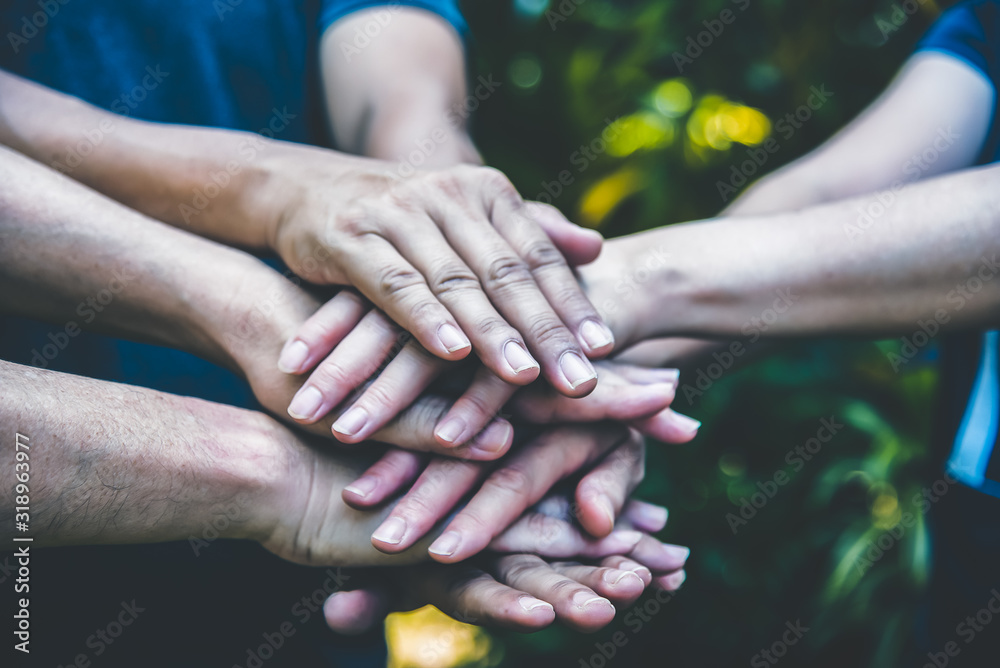 People hands assemble as a connection meeting teamwork concept. Group of people assembly hands as business or work achievement. Man and women touch each other hands outdoor. Teamwork conceptual. - obrazy, fototapety, plakaty 