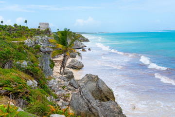 Ruins of ancient Tulum. Architecture of ancient maya. View with sea. Blue sky and lush greenery of nature. travel photo. Wallpaper or background. Yucatan. Mexico.