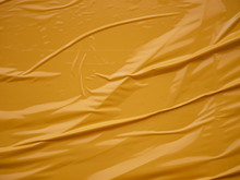 Yellow Vinyl Film Overlapped Pieces. Background From A Film With A Wavy Texture Glued To The Surface