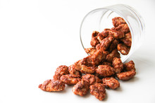Sugar Roasted Pecan Nuts (caramelized, Praline Nuts) In A Glass On A White Background, Back View