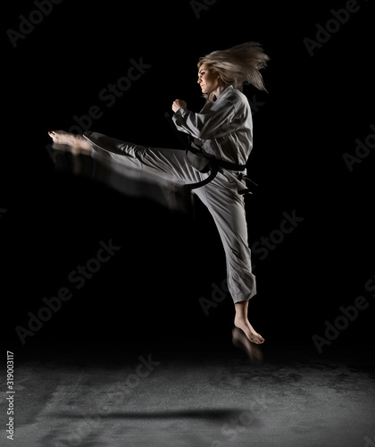 Woman in kimono practicing taekwondo Lerretsbilde