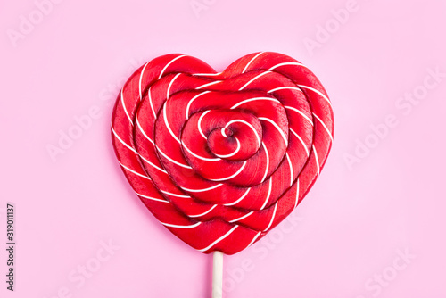 A heart-shaped lollipop on a pink background Poster Mural XXL