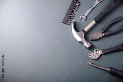 Fotografía Tools on a gray background, hammer, pliers, a place for an inscription
