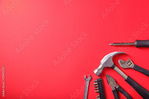 Fotomural Tools on a red background, a hammer, a place for an inscription