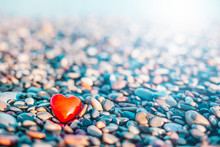 Romantic Symbol Of Red Heart On The Pebble Beach