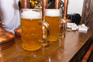 a glass of light beer in glasses on the bar