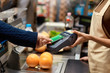 © Viktoriia - Young adult man paying for shopping in supermarket