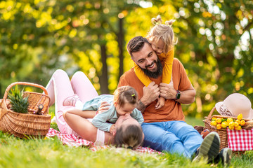 Canvas Print - Joyful family picnicking in summer park