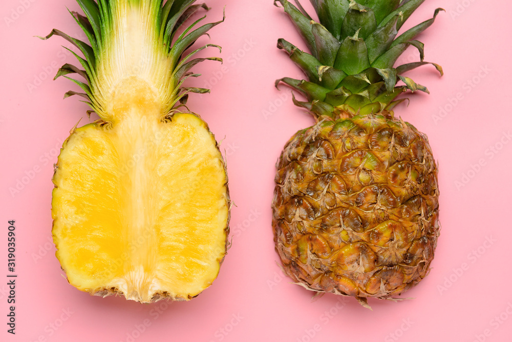 Fresh ripe pineapples on color background