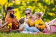 Joyful family picnicking in summer park