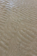 sandy beach close up. traces and ripples left by the ocean at low tide. plage de sable en gros plan. traces et vaguelettes laissées par l'ocean à marée basse.