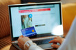 © Alliance - Closeup on woman ordering sweater in fashion online shop