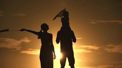 Wall Mural - Patriotic silhouette of family waving American USA flags. 