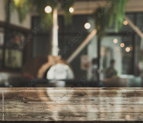 Cuadros en Lienzo Empty wooden table top with lights bokeh on blur restaurant background