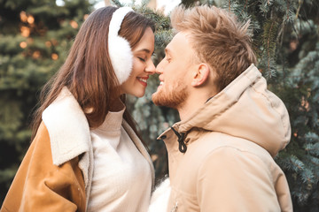 Happy young couple walking outdoors on winter day