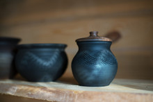 Close-Up Of Pots On Shelf At Workshop