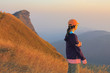 © changphoto - woman tourist standing against a background of mountains