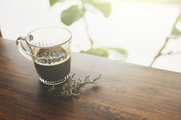 coffee cup by the window in coffee shop with vintage filter.