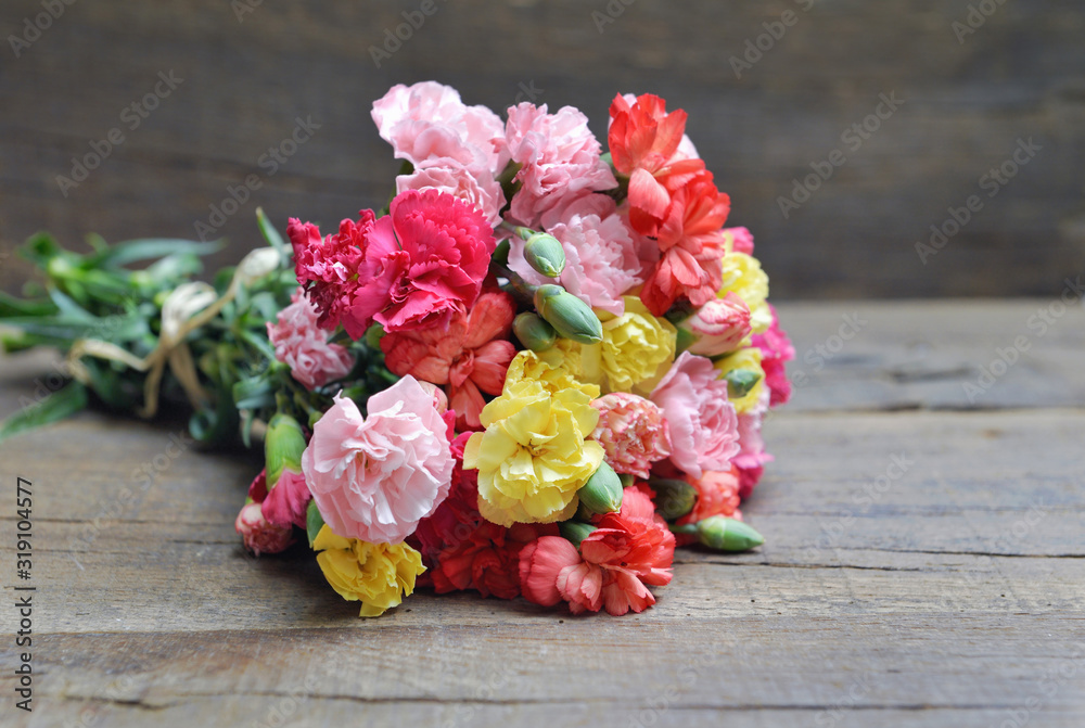 beautiful bouquet of colorful flowers carnation on a white table - obrazy, fototapety, plakaty 