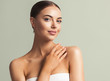 © Utkamandarinka - Beauty woman tanned skin hand touching face skin natural make up spa cosmetic concept