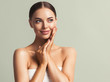 © Utkamandarinka - Beauty woman tanned skin hand touching face skin natural make up spa cosmetic concept