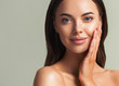 © Utkamandarinka - Beautiful woman face close up natural make up hand touching face beauty smile