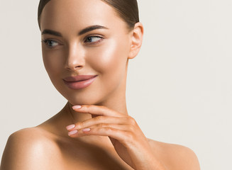 Wall Mural - beautiful woman face close up natural make up hand touching face beauty smile