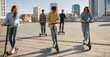 © Svitlana - Ride more. Joyful friends riding kick scooters and segways