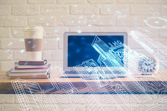 Desktop computer background in office and big town buildings hologram drawing. Double exposure. Smart city concept.