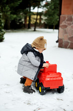 Baby Boy And Toy Car In Winter