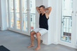Middle-aged man exercising wall sit for legs