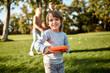 © Svitlana - Healthy lifestyle. Little boy playing frisbee in the park on a sunny day