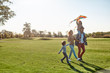 © Svitlana - Children make life important. Happy family playing a kite. Outdoor family weekend