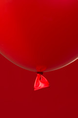 Wall Mural - red helium balloon on red background