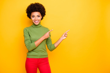 Canvas Print - Photo of cheerful positive pretty cure nice girlfriend pointing into empty space in red trousers with forefingers isolated vibrant color background