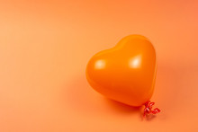 Orange Heart Ballon On Orange Background.