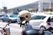 Close-Up Of Motorcycle With Crash Helmet Parked On Street