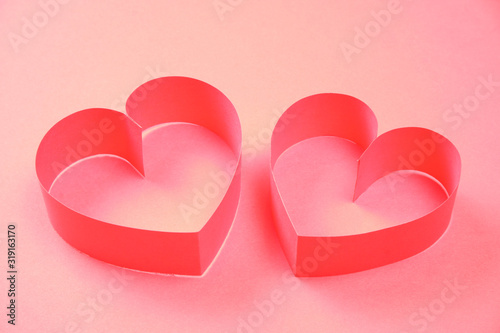 Couple of red paper hearts on pink background. Good love, valentines day, womens day banner, offer, card, invitation, flyer, poster template.