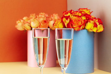 Two glasses with champagne and and bouquet of roses