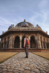 Tourist woman is walking to Isa Khan's Tomb in Humayun's Tomb complex, New Delhi, India.