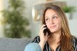 © Antonioguillem - Woman at home talks on phone looking at side