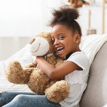 Portrait Of Cheerful Afro Girl With Big Teddy Bear