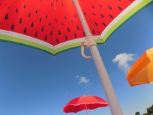 Low Angle View Of Umbrellas Against Blue Sky